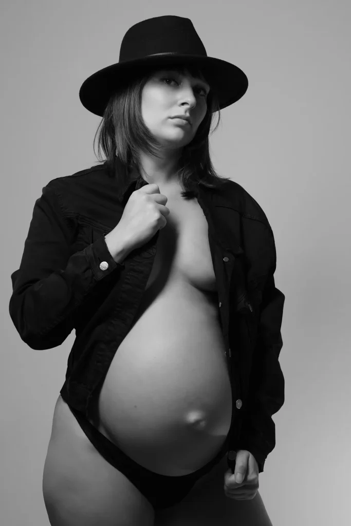 a pregnant woman wearing a hat and a shirt