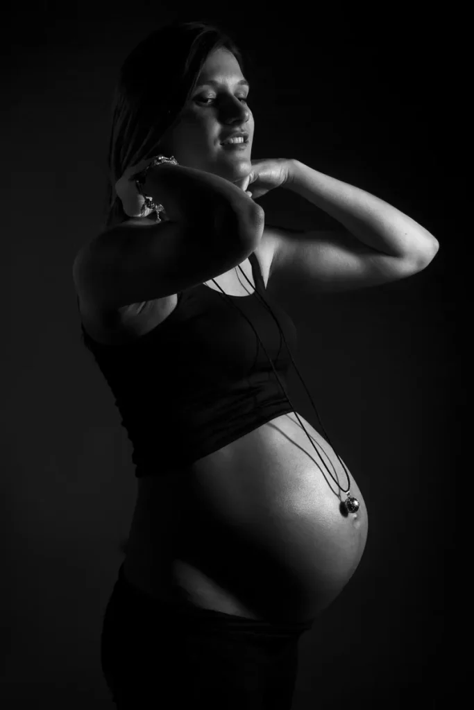 a pregnant woman with her hands behind her head