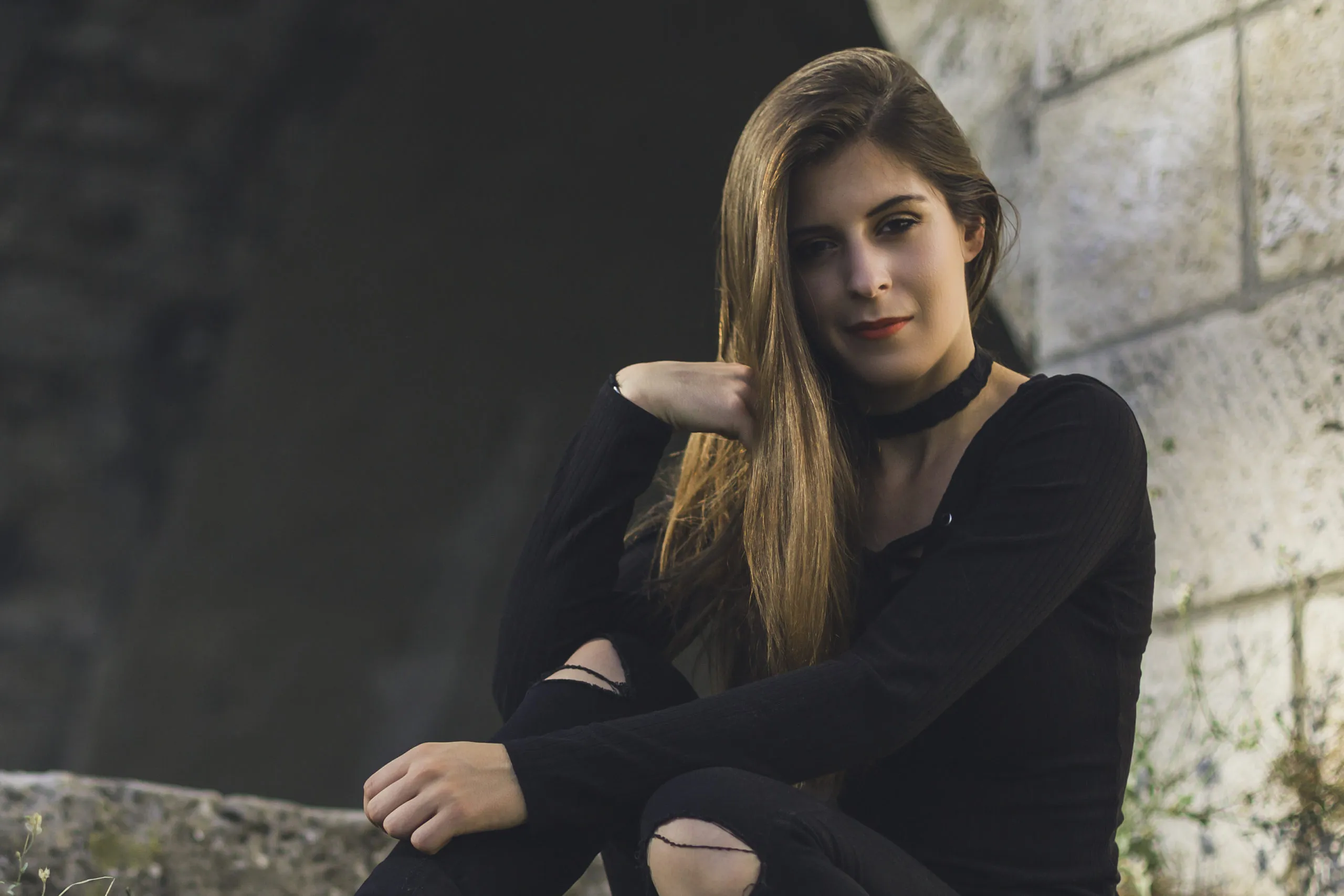 a woman sitting on a rock