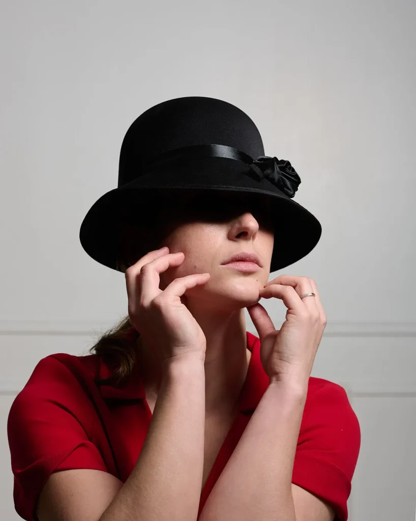 a woman wearing a hat and red shirt